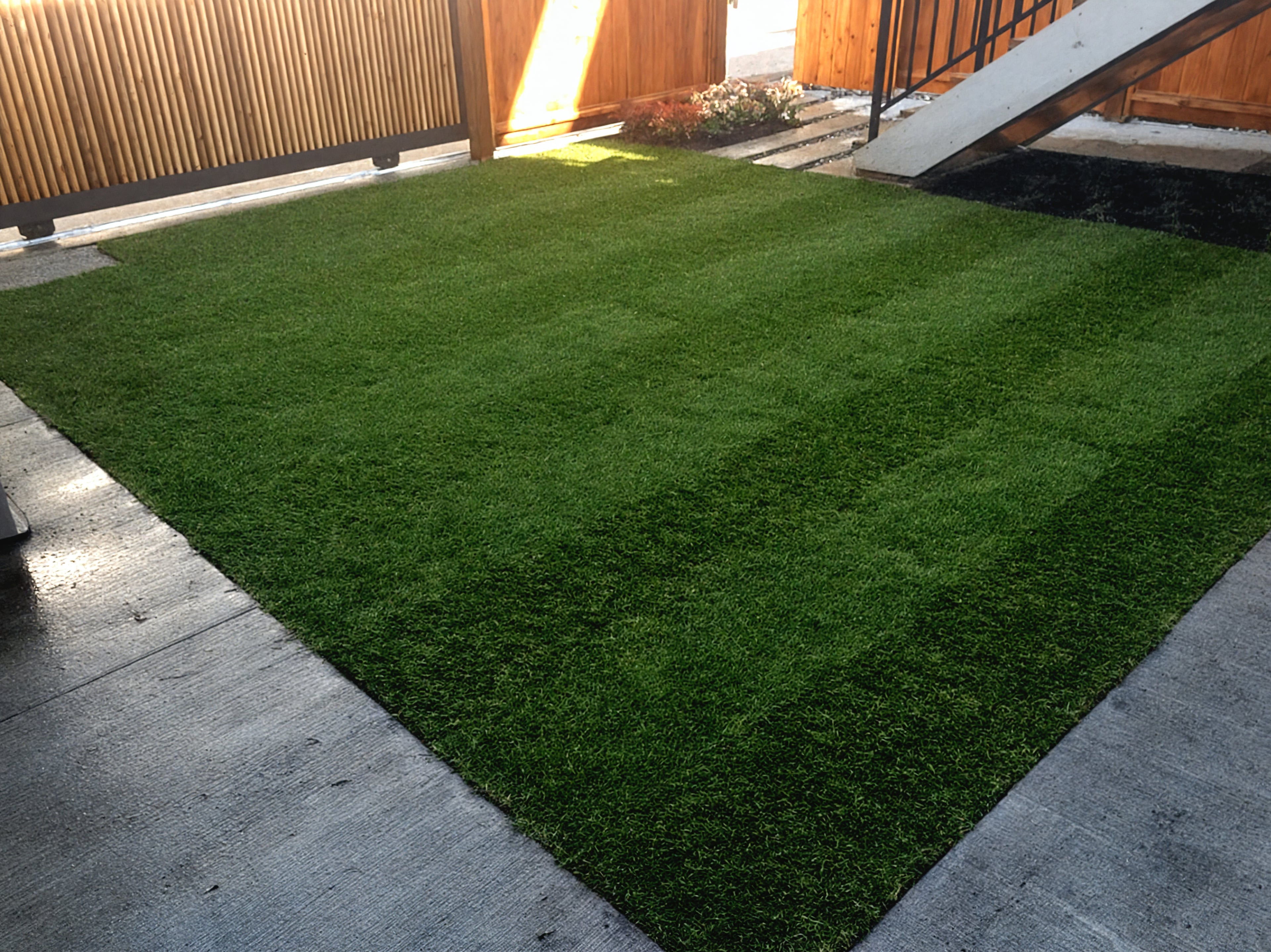 Garden beds, Sod lawn, Concrete slabs and River rock at the East 22nd project.