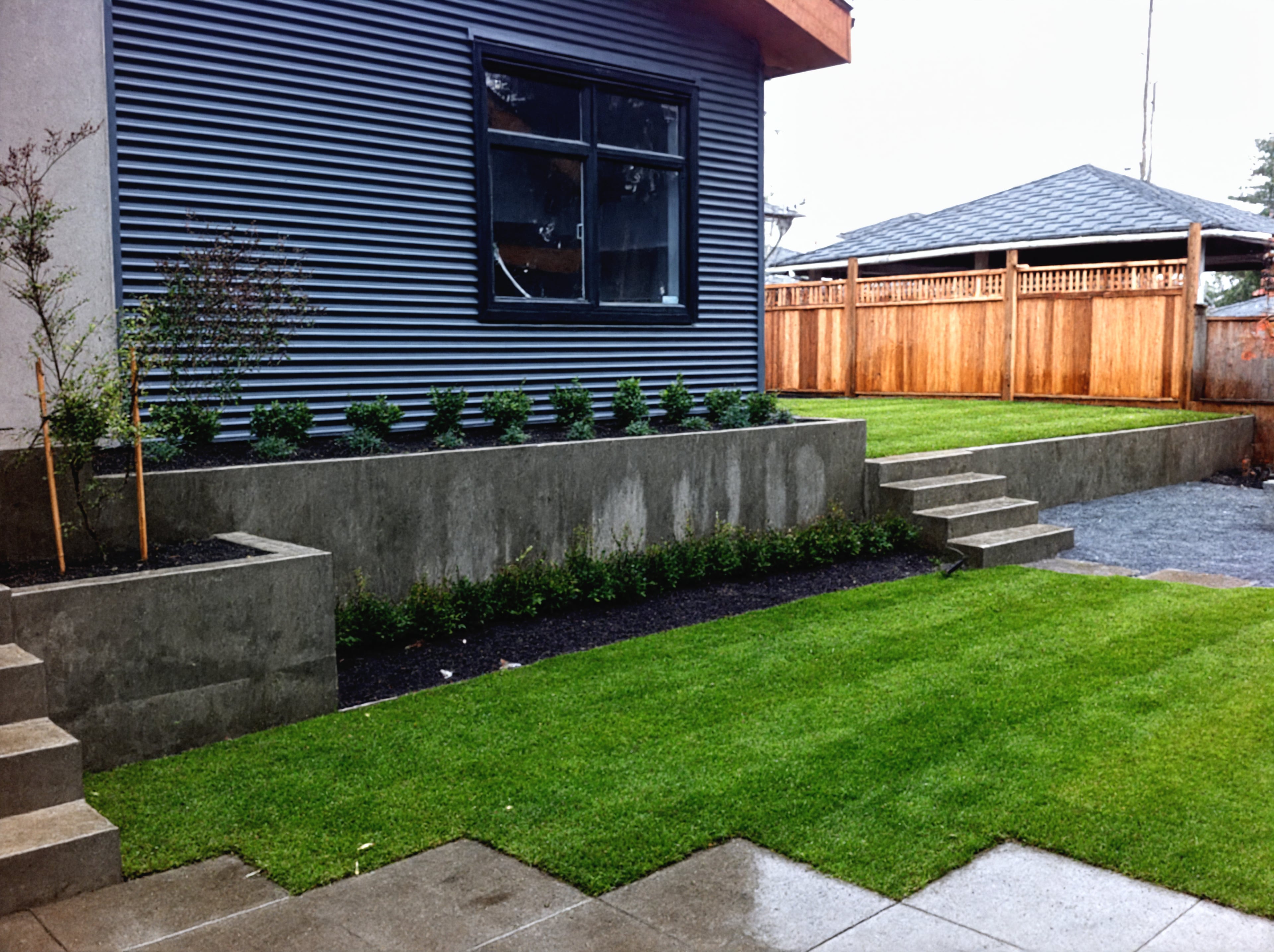 Sod lawn, Concrete slabs, Hedges and Plants at the West 32nd project.