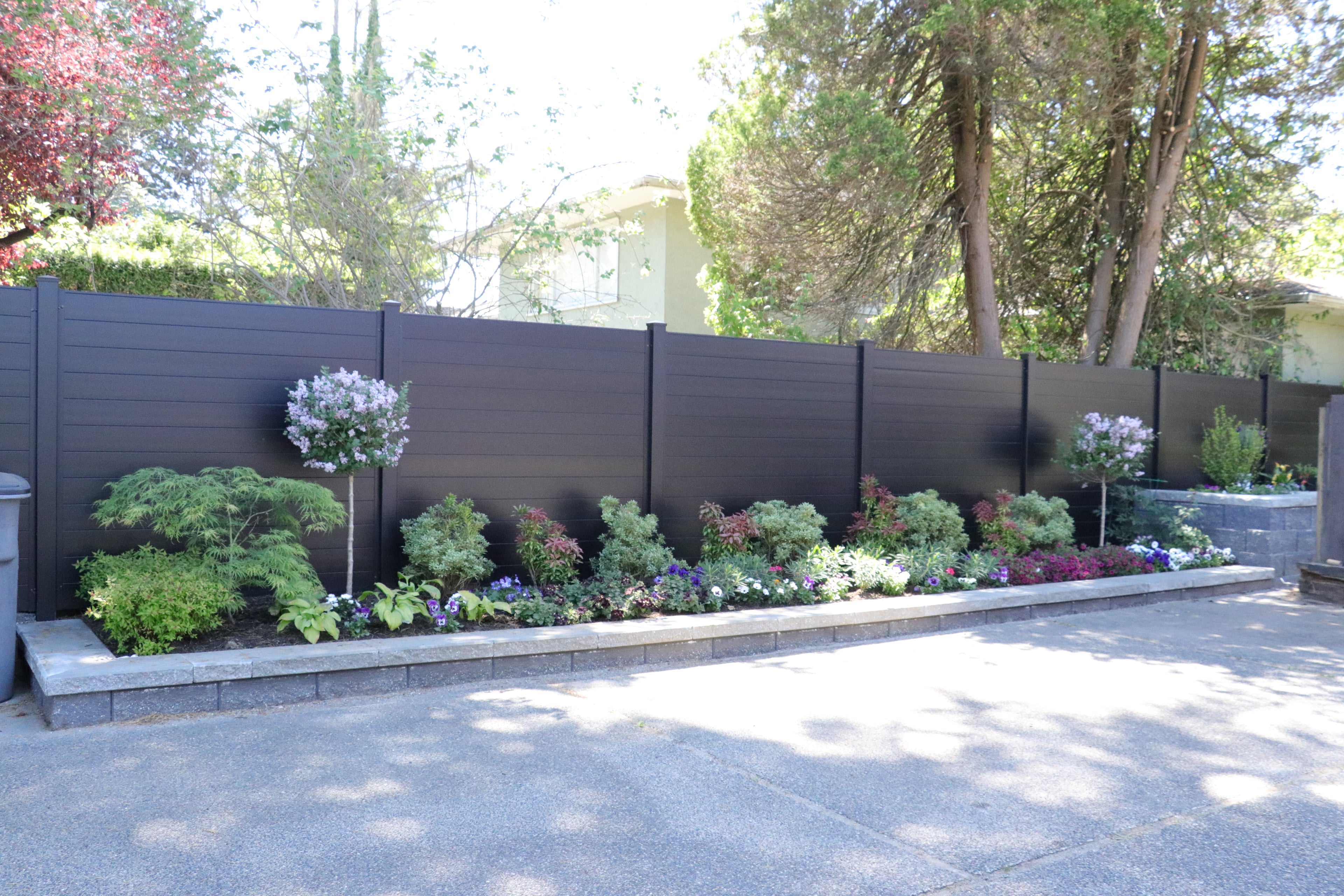 Aluminum fencing, Retaining walls, Seasonal planting and Hedge trimming at the West 35th project.