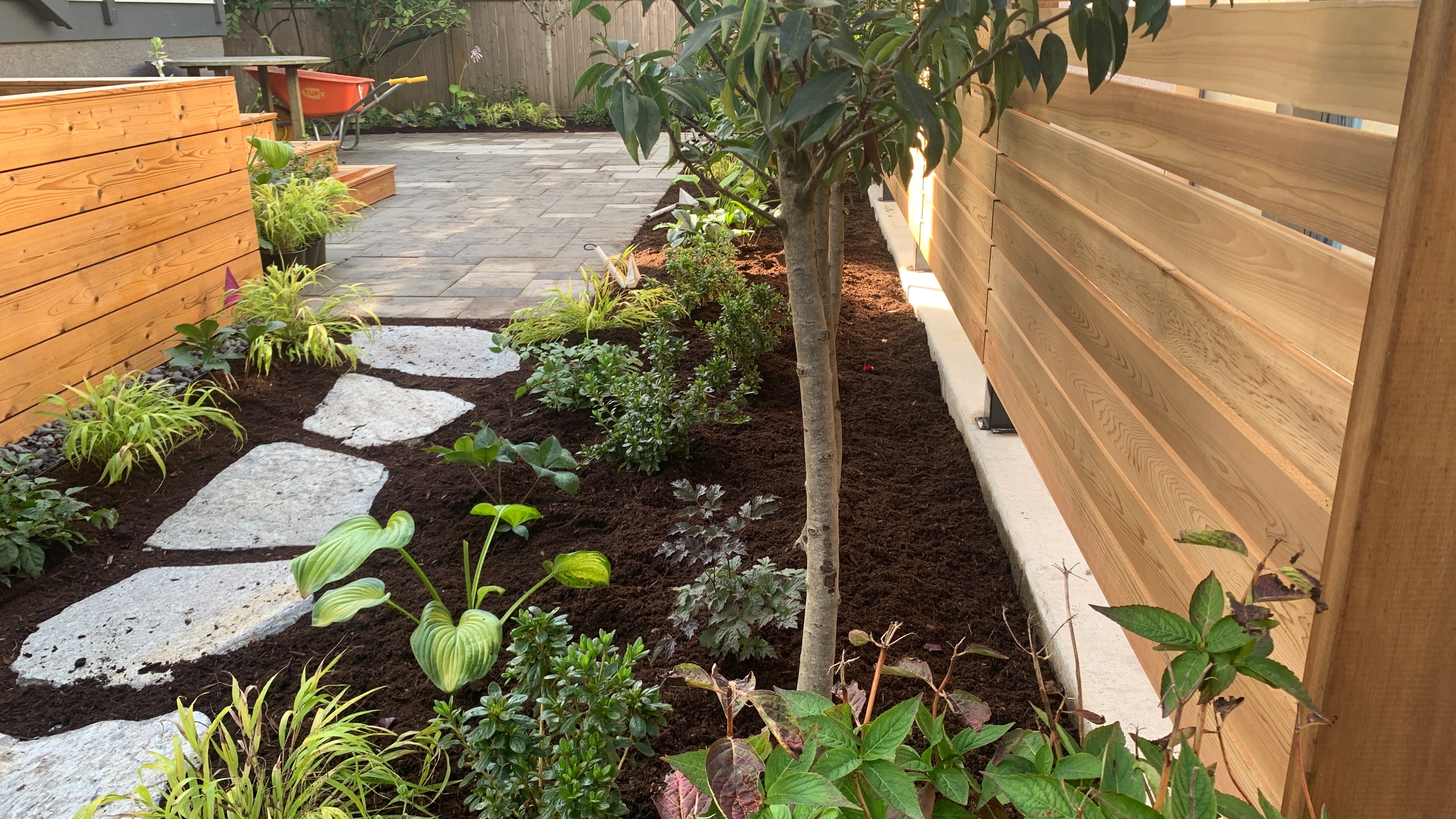 Natural stone pavers, Garden boxes, Hedges and Outdoor Lighting at the West 15th project.